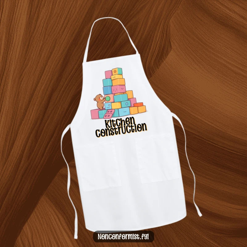 Funny Bear Apron showcasing a small bear character building a lopsided tower of colorful, unusual blocks, adding humorous charm to kitchen activities.