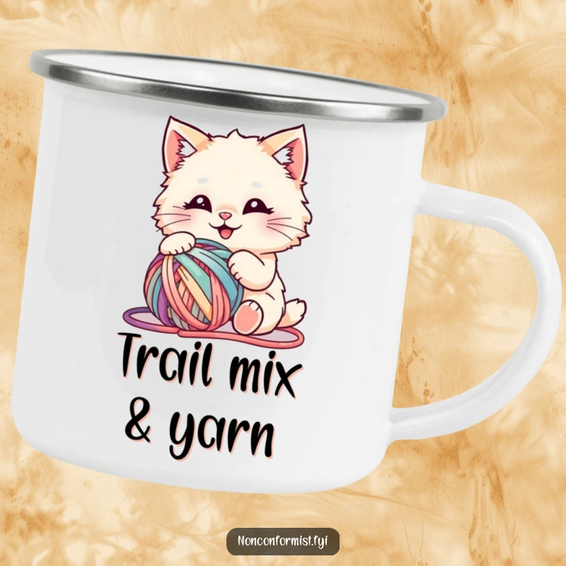 Funny camping mug featuring a fluffy cat happily playing with a tangled, vibrant ball of yarn, ready for outdoor fun.