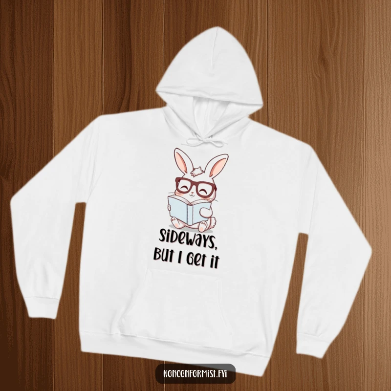 Funny bunny hoodie with a curious rabbit wearing glasses, reading a sideways book, offering cozy and intellectual fun.