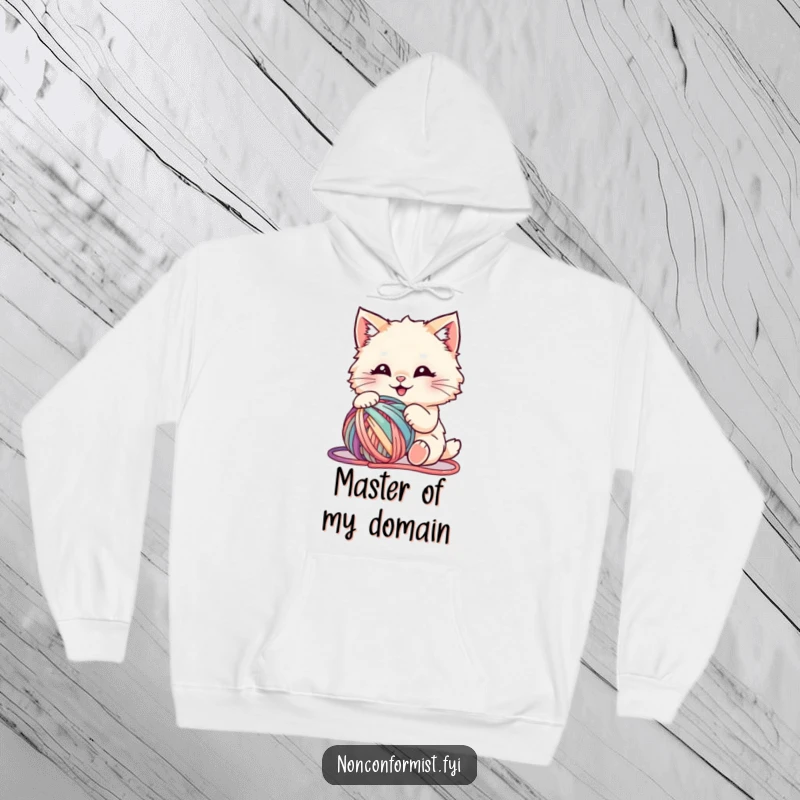 Funny hoodie depicting a fluffy cat enthusiastically playing with a tangled mess of multi-colored yarn, exuding playful energy.