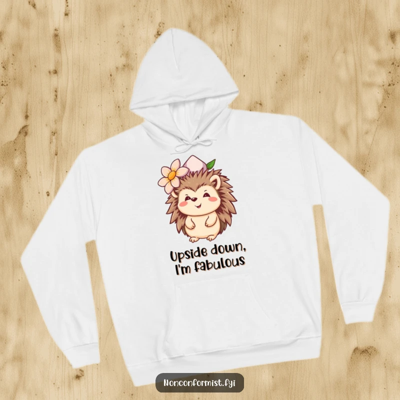 Funny hedgehog hoodie featuring a smiling animal with an upside-down flower hat, offering cozy and humorous attire.