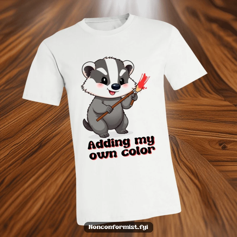 Funny T-Shirt of a happy badger enthusiastically painting a vibrant red stripe onto its own grey fur, celebrating art.