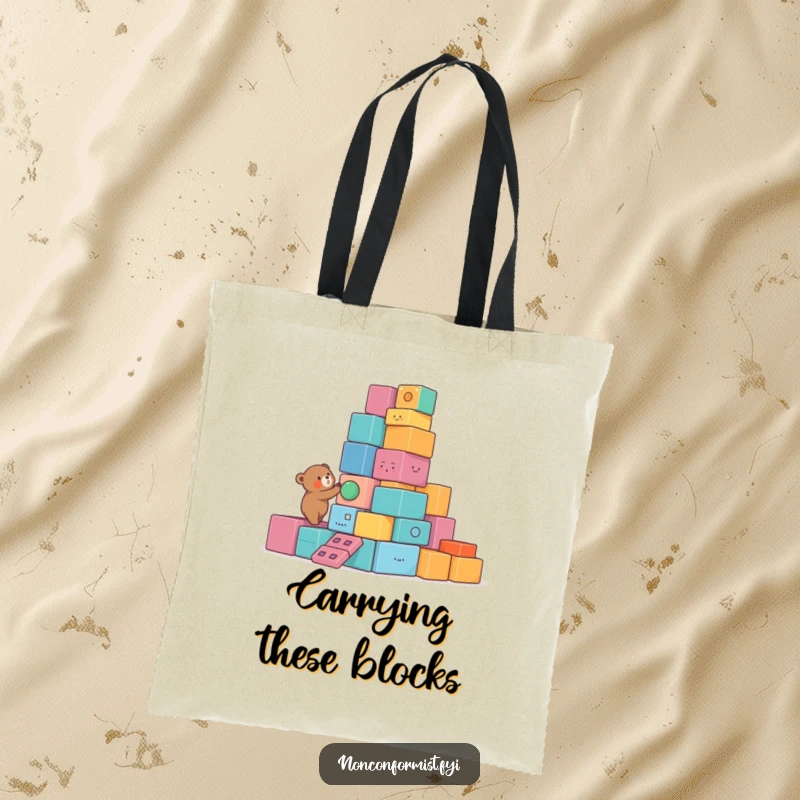 Funny Bear Tote Bag with a small bear character building a lopsided tower of colorful, unusual blocks, a humorous and practical accessory.